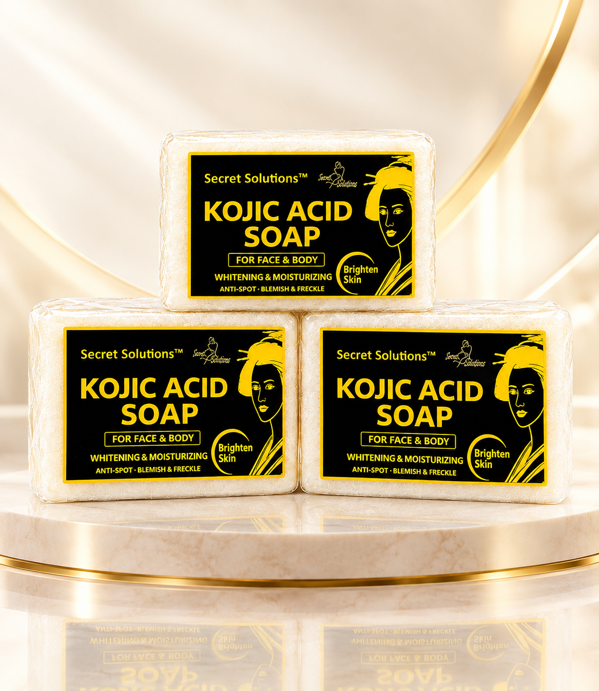 Three bars of Secret Solutions Kojic Acid Soap arranged in a pyramid on a marble pedestal with gold accents. The soap bars are wrapped in clear plastic and feature bold black and yellow labels with a stylized illustration of a woman's face.