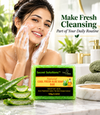 A woman with cleansing foam on her face is shown beside a bar of Secret Solutions Natural Cool Fresh Aloe Soap Bar, with aloe leaves and a bathroom setting in the background.