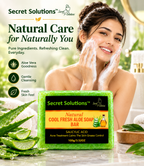 A woman with soap lather on her face is shown beside a bar of Secret Solutions Natural Cool Fresh Aloe Soap Bar. The ad includes text highlighting aloe vera goodness, gentle cleansing, and fresh skin feel, with a bright green soap bar in the foreground and a soft bathroom-like background.
