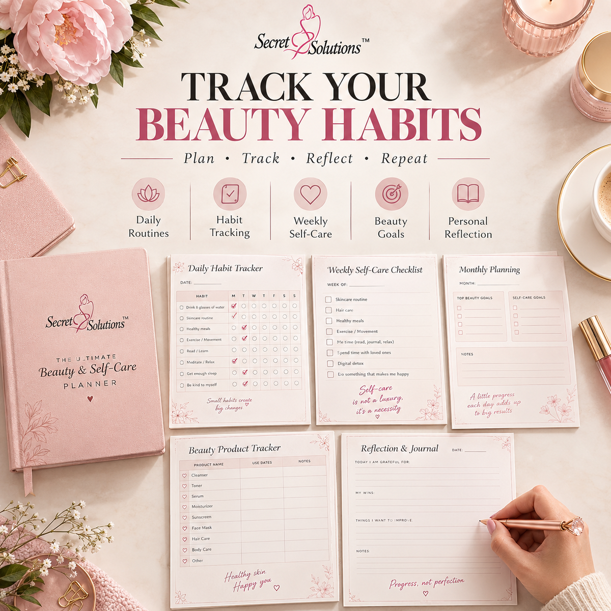 A styled flat-lay of the Secret Solutions 'The Smart Beauty & Self Care Planner' on a light pink background, showing the pink hardcover planner, several open tracking sheets, decorative flowers, a candle, and a hand writing in the journal.